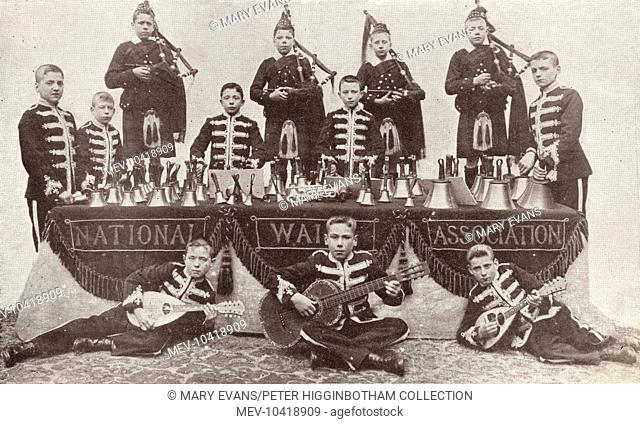 A boys' band of the National Waifs Association, otherwise known as Dr Barnardo's. The instruments include hand bells, bagpipes, mandolins, and a guitar