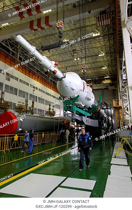 At the Baikonur Cosmodrome in Kazakhstan, technicians complete the mating of the stages of the Soyuz TMA-16 rocket in its integration facility on Sept
