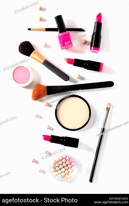 Make-up artist's professional tools, shot from the top on a white background. Lipstick, brushes, pears and other products