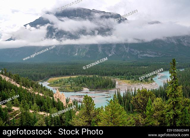 Panoramic image of the Hoodoos close to Banff with the Bow river and the Mount Rundle under clowds in the background, Banff National Park, Alberta, Canada