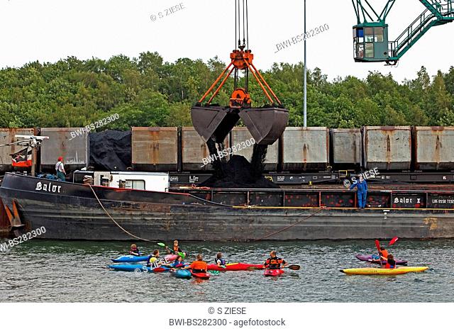 canoeists in front of a cargo ship in the coal harbour Auguste Victoria at the Wesel-Datteln Canal, Germany, North Rhine-Westphalia, Ruhr Area, Marl