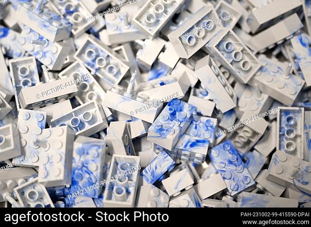 02 October 2023, Saxony, Dresden: Clamping bricks lie in a container at an injection molding machine at the Dresden-based recycling start-up HolyPoly