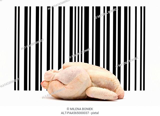 Food concept, raw whole chicken in front of bar code