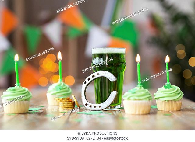 glass of beer, cupcakes, horseshoe and gold coins