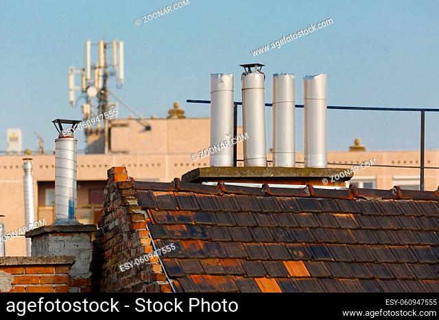 Chimneys on roofs in late afternoon light