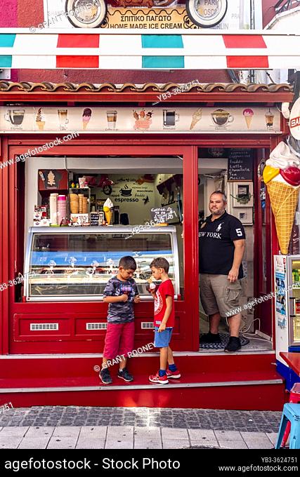 Two Local Boys Buying Ice Cream From A Shop In The Town Of Parga, Preveza Region Greece