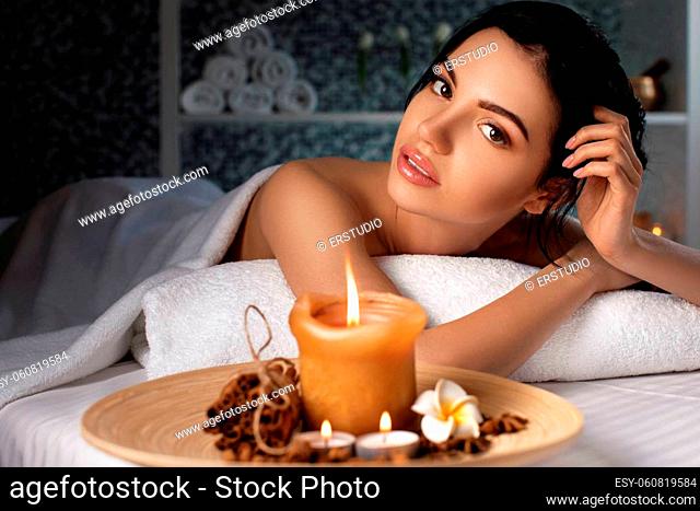 Relaxed beautiful young woman in spa salon. Beauty treatment
