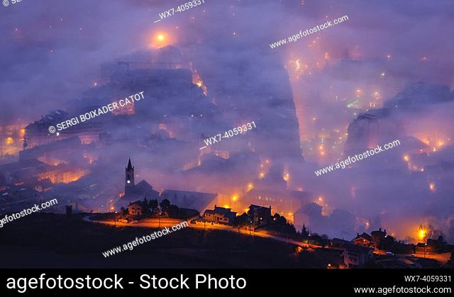 Berga city among fog, in the morning twilight - blue hour, seen from the Figuerassa viewpoint (BerguedÃ , Barcelona, Catalonia, Spain, Pyrenees)