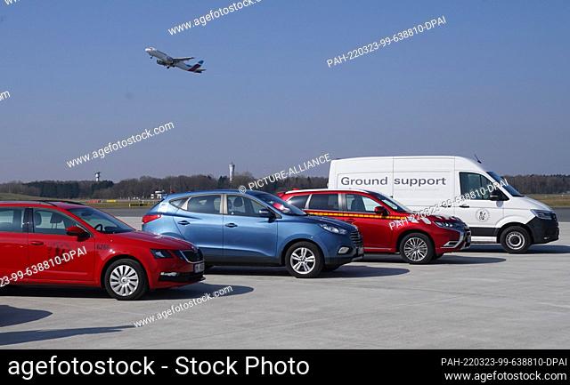23 March 2022, Hamburg: Vehicles powered by electricity and hydrogen are parked on the apron at Hamburg Airport. Hamburg Airport has become the first German...