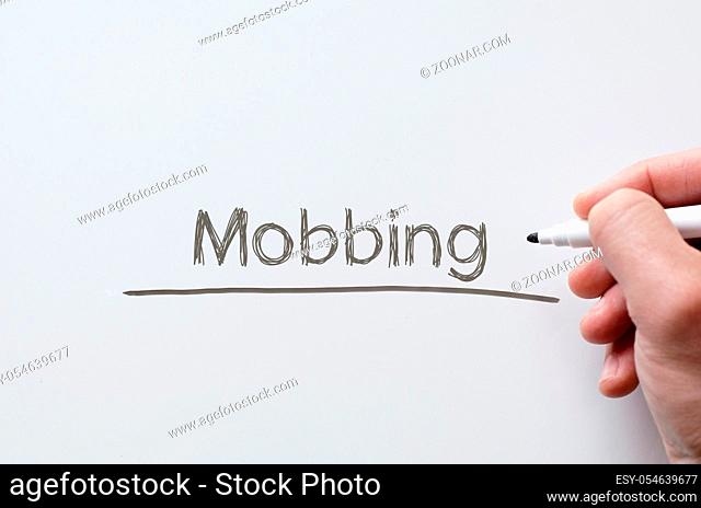 Human hand writing mobbing on whiteboard