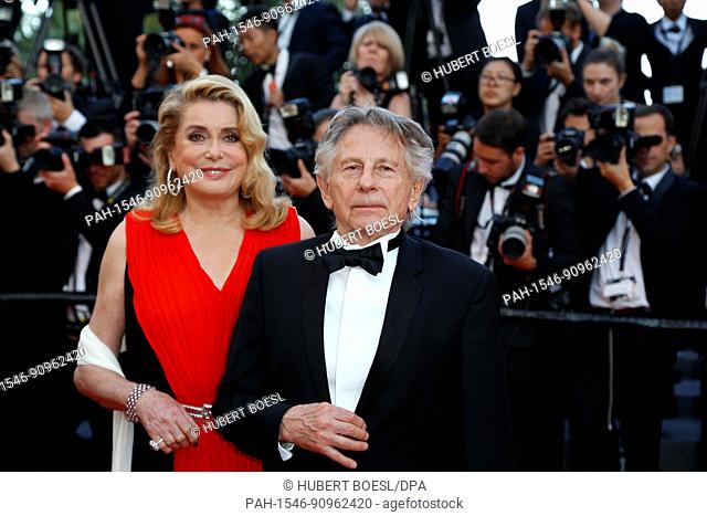 Catherine Deneuve and Roman Polanski attend the red carpet of the 70th Anniversary Celebration of the Cannes Film Festival at Palais des Festivals in Cannes