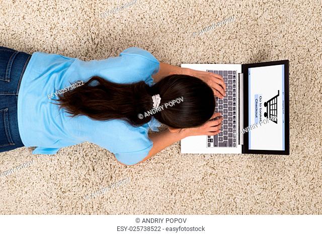 High Angle View Of Young Woman Doing Online Shopping On Laptop