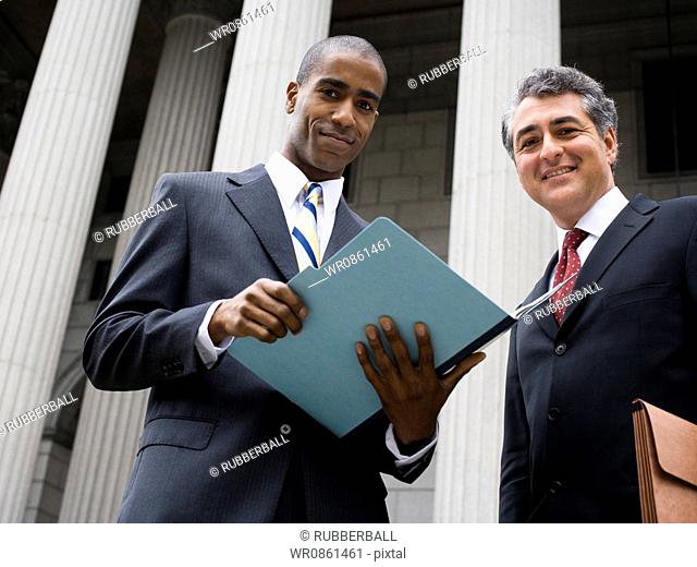 Low angle view of two lawyers smiling