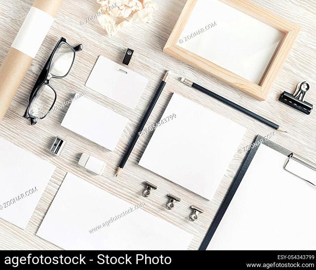 Blank corporate stationery set on light wood table background. Branding mock up. Flat lay