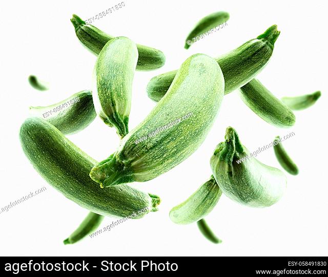 Green zucchini levitate on a white background