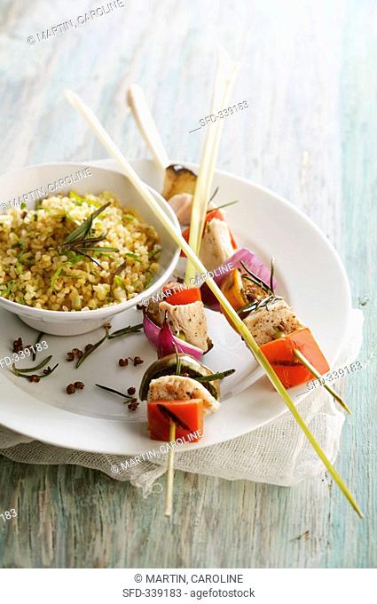 Chicken and vegetables on lemon grass skewers with bulgur