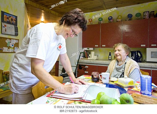 Ambulatory care of the German Red Cross, nurse Anke Lehmann preparing breakfast for a heart attack patient, Treuenbrietzen, Brandenburg, Germany, Europe