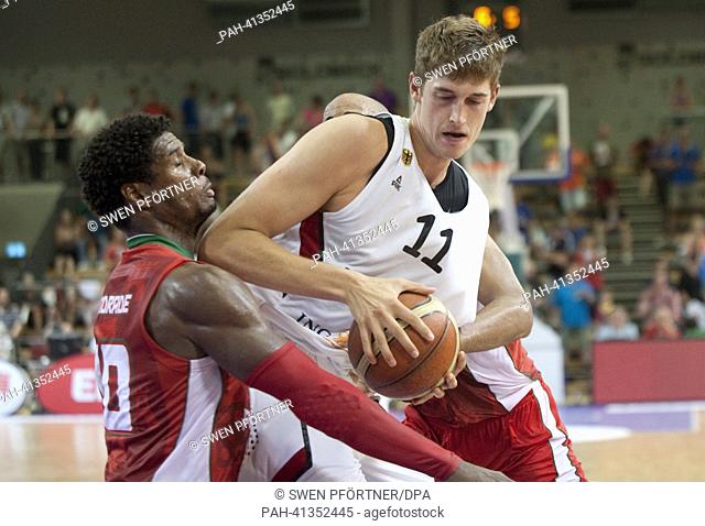 Germany's Tibor Pleiss (L) plays against Portugal's Carlos Andrade during the international basketball match Germany vs. Portugal at S-Arena in Goettingen