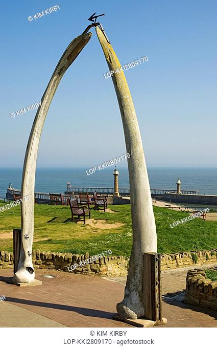 England, North Yorkshire, Whitby, View through the Whalebone Arch at West Cliff towards Whitby Harbour in the background