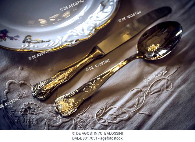 Porcelain plate and cutlery on a laid table, court life in the Stupinigi hunting lodge, Italy, 18th century. Historical re-enactment