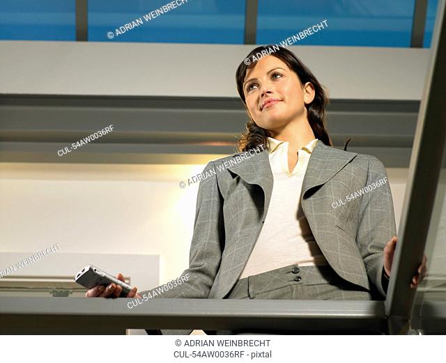 Businesswoman standing on balcony
