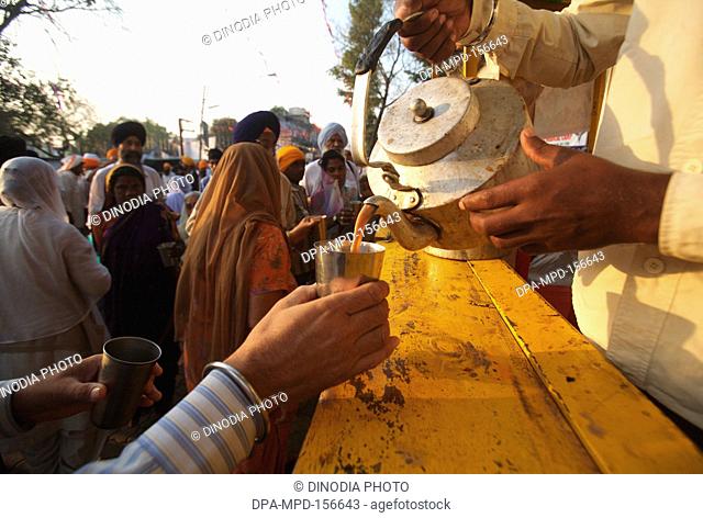 Tea being served to the devotees in the in the compound of Sachkhand Saheb Gurudwara in Nanded ; Maharashtra ; India