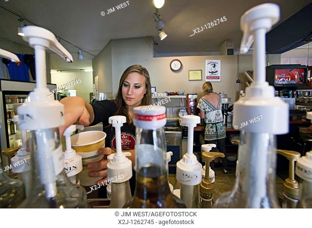 Alamosa, Colorado - An Americorps volunteer makes a drink at Milagros Coffee House  Profits from the coffee house support La Puente