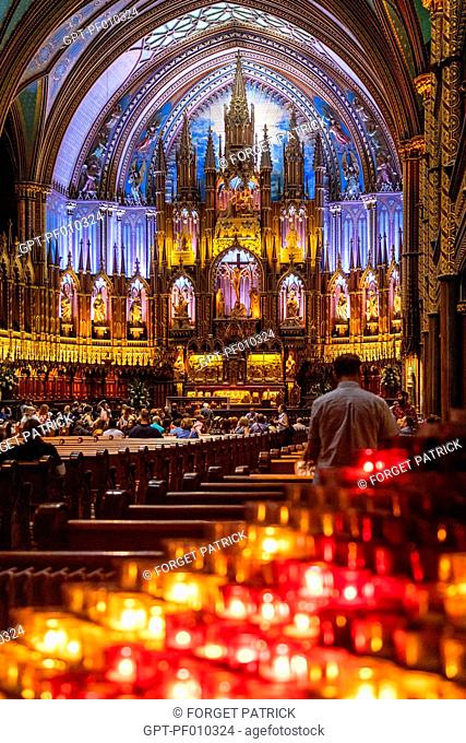 CANDLES IN FRONT OF THE SANCTUARY AND CHOIR ALTARPIECE IN THE NOTRE-DAME OF MONTREAL BASILICA, MONTREAL, QUEBEC, CANADA
