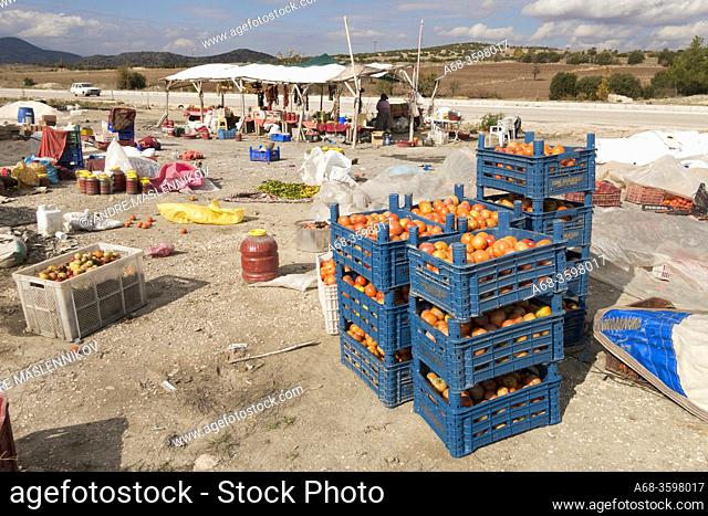 A woman sells fresh, dried and pickled vegetables on the highway in Turkey