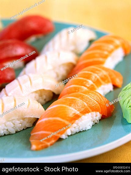 Assorted nigiri-sushi on blue plate