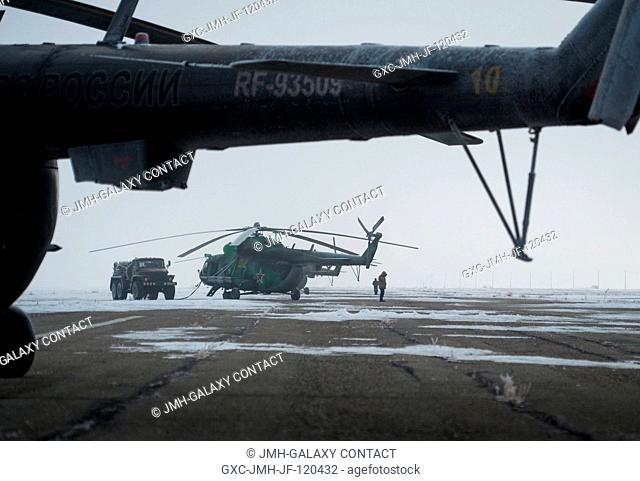 Search and Rescue helicopters are seen grounded by low visibility at the Arkalyk Airport in Kazakhstan on Saturday, March 16, 2013