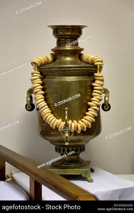 A device for boiling water and making tea. Traditional Russian samovar with dried ring-shaped rolls