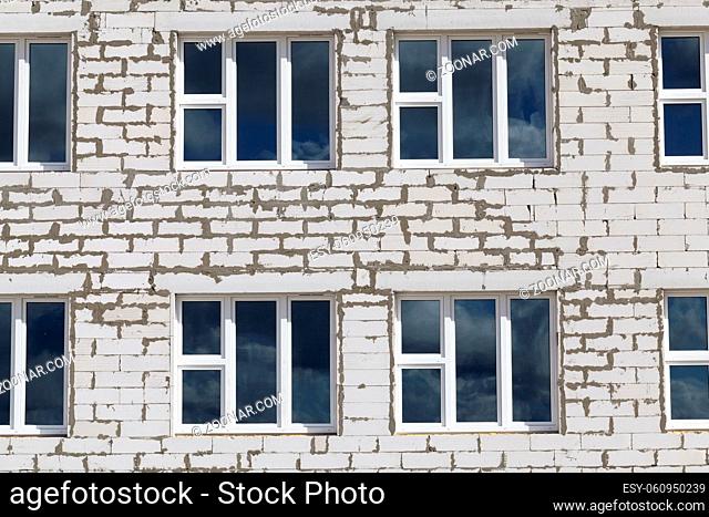 new windows in a brick building under construction in the city, closeup