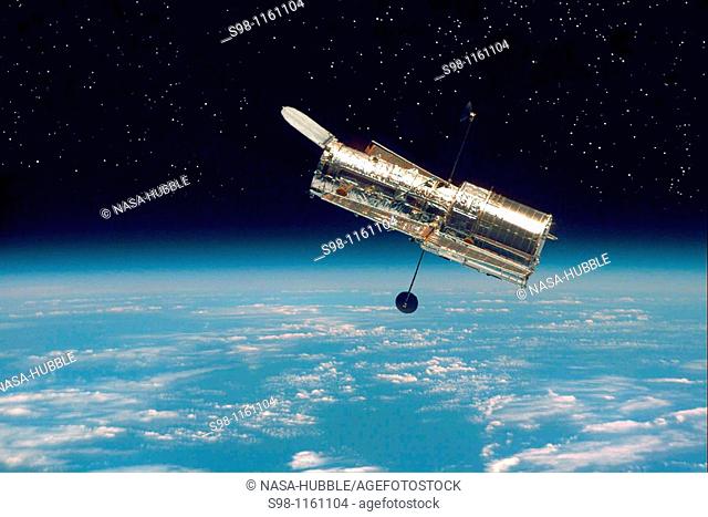 The Hubble Space Telescope hovers at the boundary of Earth and space in this picture, taken after Hubble’s second servicing mission in 1997  Hubble drifts 353...