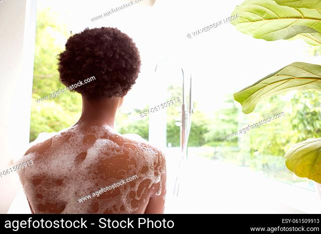 Rear view of woman in a bathtub