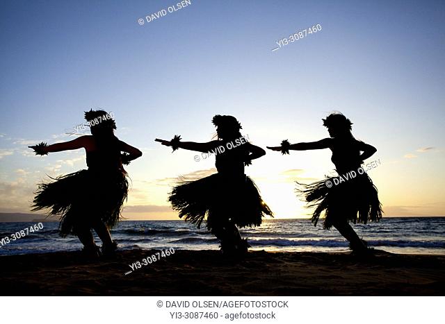Three hula dancers at sunset at Wailea, Maui, Hawaii