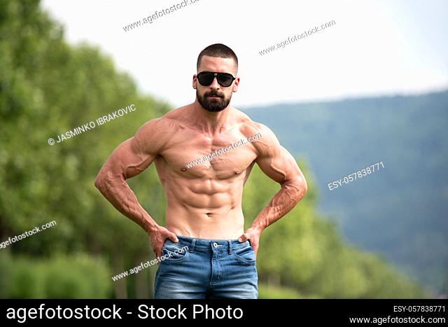 Handsome Beard Man Standing Strong and Posing at Outdoors - Background Nature of Leaves