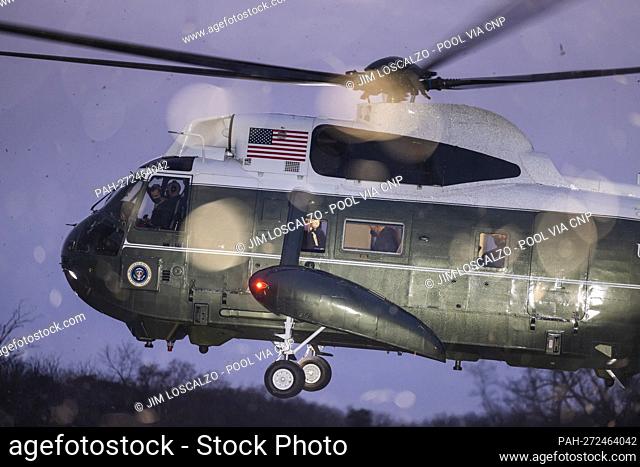 US President Joe Biden (C) and First Lady Jill Biden (L) are seen on Marine One as they arrive at George Washington’s Mount Vernon home to attend the National...
