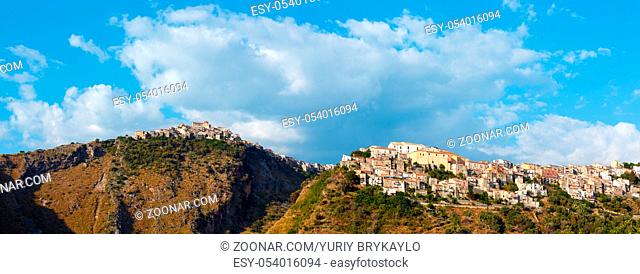 Calabria summer view with beautiful old village on mountain hill top above Tyrrhenian sea coast, Italy. Two shots stitch high-resolution panorama