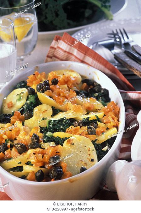Kale & potato bake with carrots and capers in baking dish