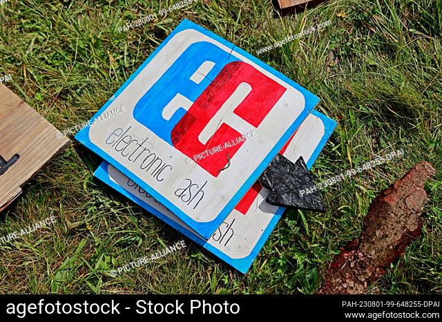 01 August 2023, Saxony-Anhalt, Elend: Signs for EC card eletronic cash lie on a festival lawn in Elend . For the festival ""Rocken am Brocken"" , from 3