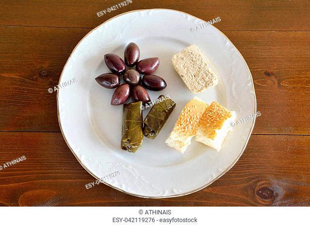Fasting food concept of plate with olives, dolma, halva and lagana