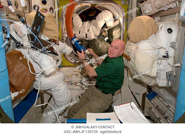 European Space Agency astronaut Andre Kuipers, Expedition 30 flight engineer, works in the Quest airlock of the International Space Station