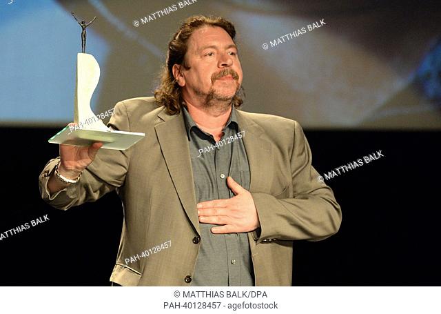 German actor Armin Rohde cheers as he receives the acting award at the 24th international film festival of Emden-Norderney in Emden, Germany, 9 June 2013