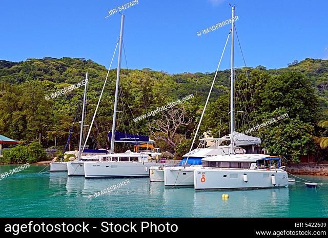 Sailboats for hire in the harbour, Jetty of La Digue Island, Seychelles, Africa