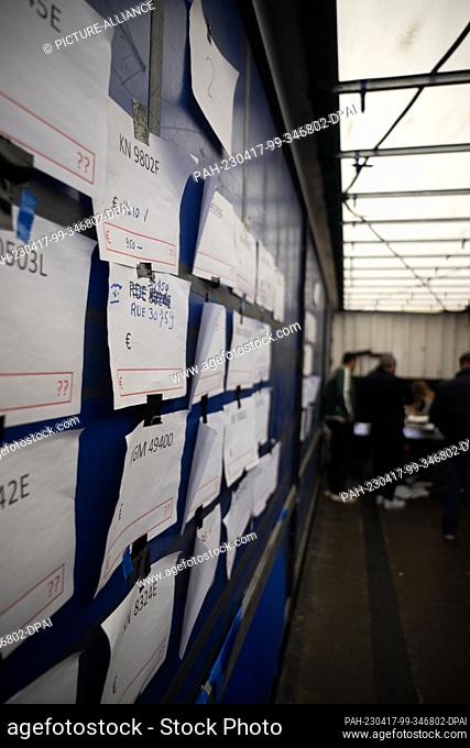 PRODUCTION - 17 April 2023, Hesse, Weiterstadt: Slips of paper on which previously paid claims are noted hang in a truck during a strike by truck drivers of a...