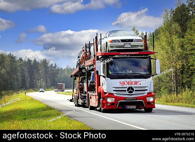 Mercedes-Benz vehicle carrier truck Sjoberg Autonkuljetus Oy hauls cars on road 25 on a sunny day of autumn. Raasepori, Finland. September 9, 2021