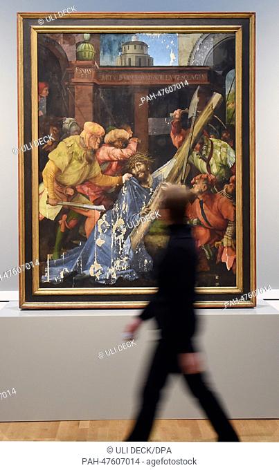 A visitor of the Staatliche Kunsthalle Karlsruhe looks at a painting 'bearing of the cross' by Mathis Gothart Nithart, also known as Gruenwald