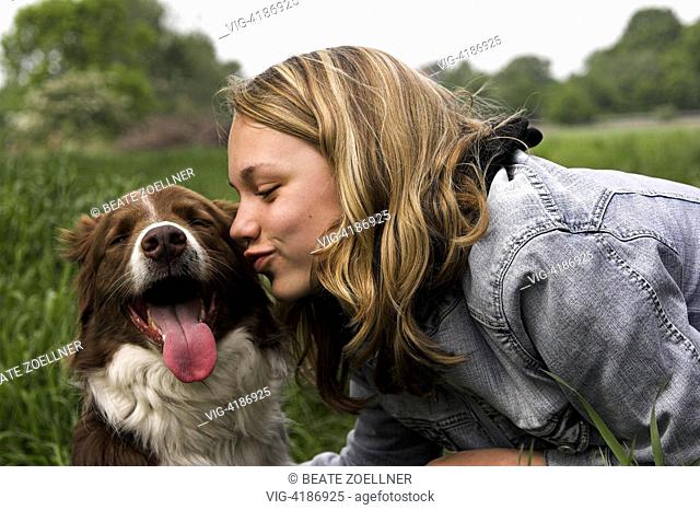 Teenage girl kissing a dog Stock Photos and Images | agefotostock