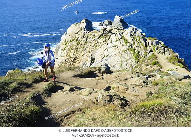 Solo female tourist at the tip of Estaca de Bares cape, Coruna province, Galicia, Spain, Europe